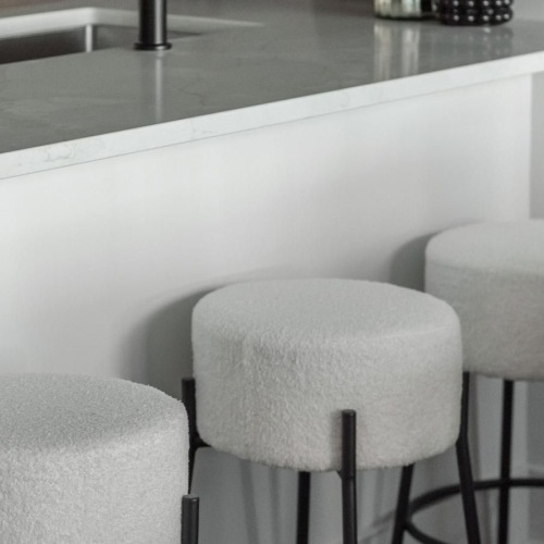 a kitchen with stools and a countertop