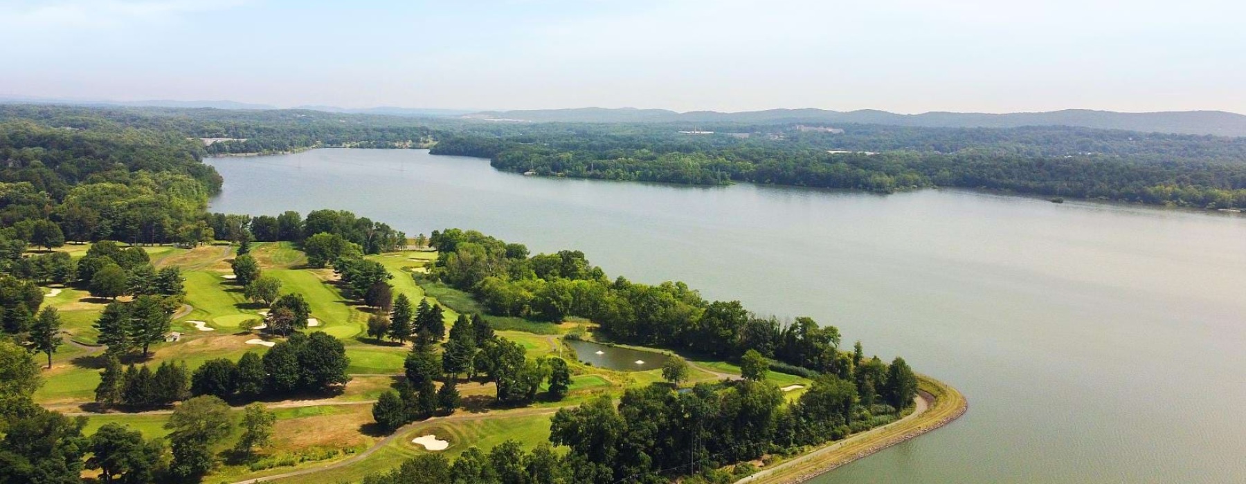 a body of water with trees around it
